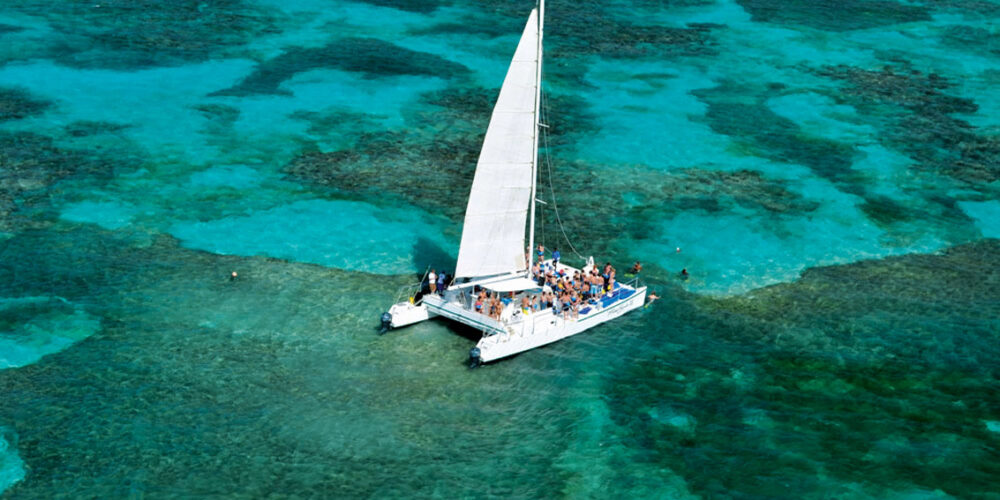 Exciting aquatic adventure featuring a combination of sailing splash activities, speed boat rides, snorkeling explorations, and relaxing catamaran cruises, offering a diverse range of experiences on the water with vibrant marine life and stunning ocean views