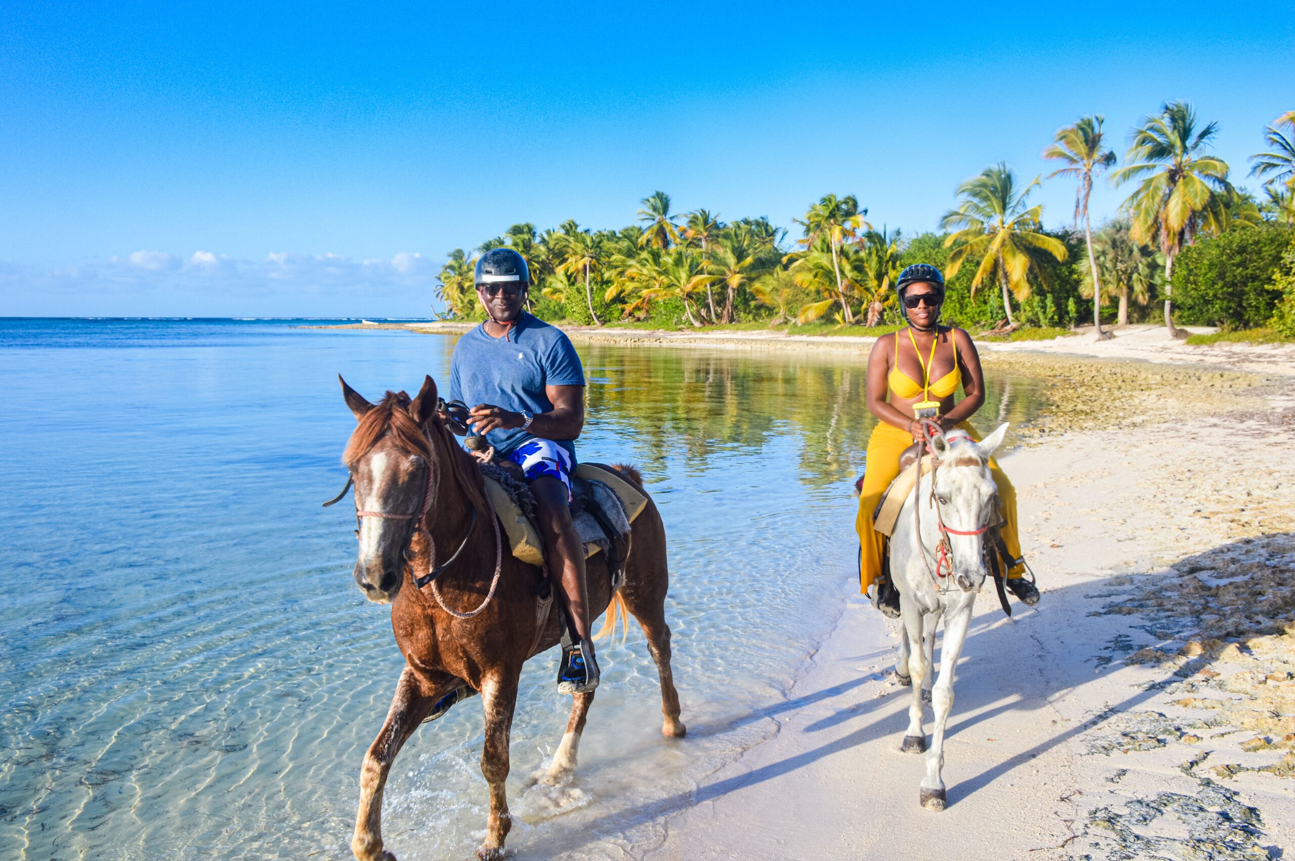 Scenic horse riding experience on the beach, with riders trotting along the shoreline, the gentle waves lapping at their feet, and the sun setting in the background, creating a tranquil and picturesque coastal adventure.