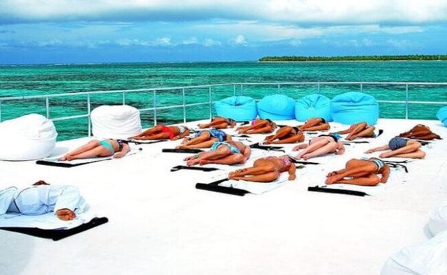 Serene ocean spa setting, featuring luxurious treatment rooms with panoramic ocean views, where guests enjoy relaxing massages and rejuvenating therapies amid the soothing sounds of the waves and a tranquil ambiance.