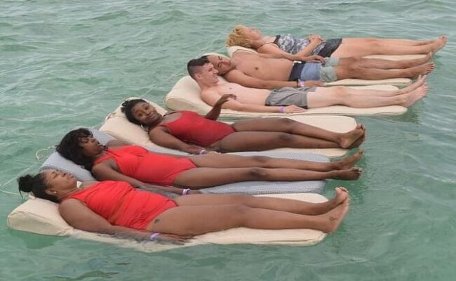 Serene ocean spa setting, featuring luxurious treatment rooms with panoramic ocean views, where guests enjoy relaxing massages and rejuvenating therapies amid the soothing sounds of the waves and a tranquil ambiance.