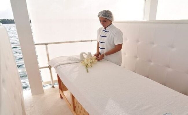 Serene ocean spa setting, featuring luxurious treatment rooms with panoramic ocean views, where guests enjoy relaxing massages and rejuvenating therapies amid the soothing sounds of the waves and a tranquil ambiance.