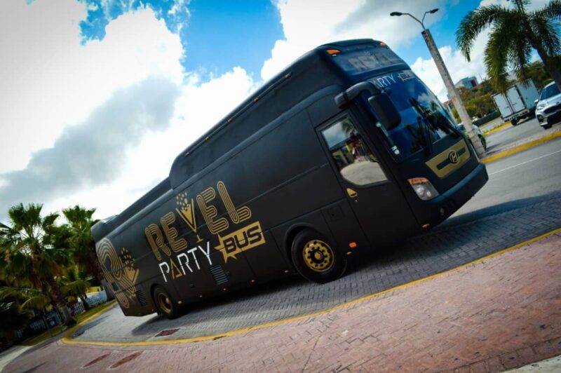 Fun-filled party bus interior, featuring vibrant lighting, comfortable seating, and music, with guests dancing and enjoying themselves while traveling to various destinations in a lively and festive atmosphere