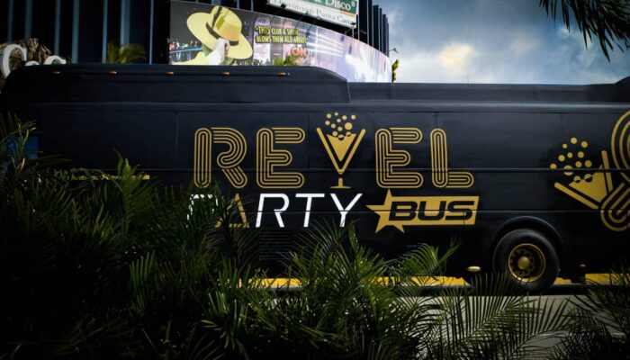 Fun-filled party bus interior, featuring vibrant lighting, comfortable seating, and music, with guests dancing and enjoying themselves while traveling to various destinations in a lively and festive atmosphere