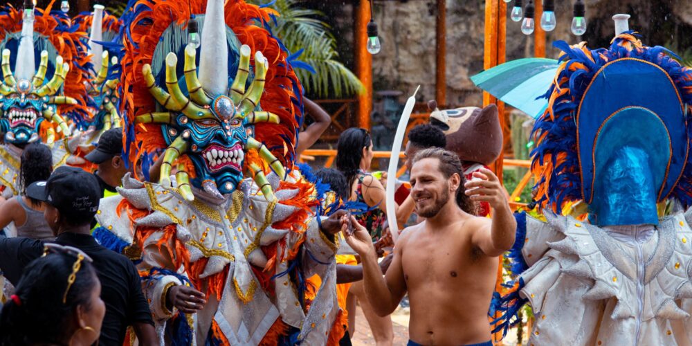 Colorful Carnival Show featuring lively dancers in extravagant costumes, vibrant masks, and rhythmic music, celebrating the festive spirit and cultural heritage of the Caribbean.