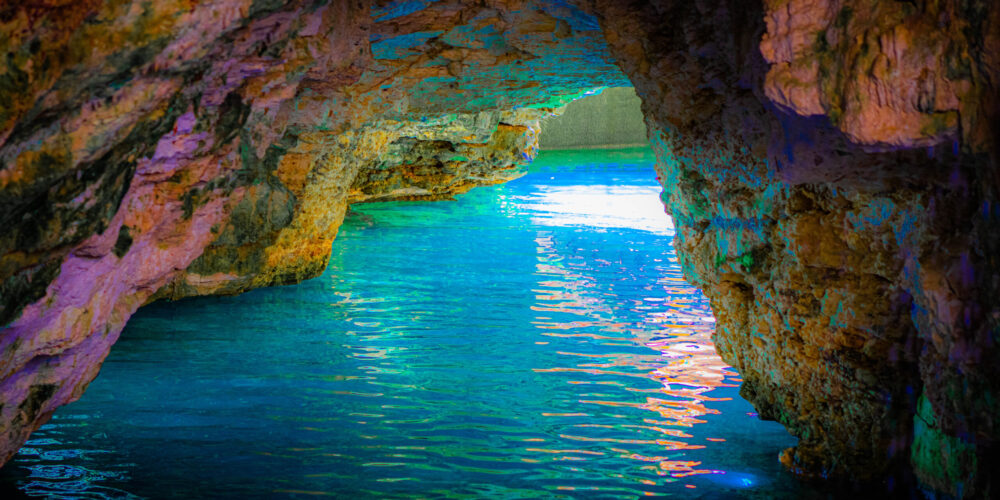 Refreshing cave swim in crystal clear water, surrounded by stunning rock formations and natural beauty, offering a serene and unique swimming experience in an underground cenote.