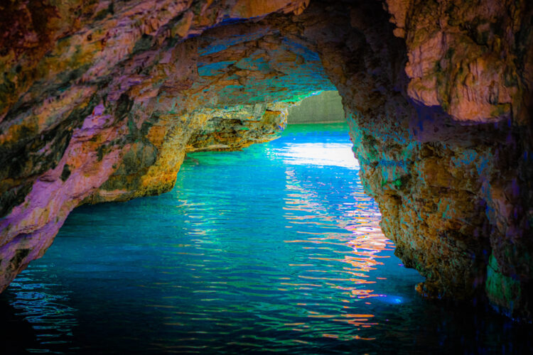 Refreshing cave swim in crystal clear water, surrounded by stunning rock formations and natural beauty, offering a serene and unique swimming experience in an underground cenote.