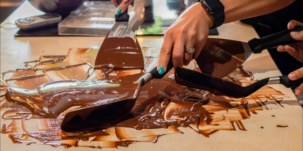 Hands-on Chocolate Master Class, teaching participants how to craft rich, artisanal chocolate from cacao beans, with techniques for tempering, molding, and flavoring.