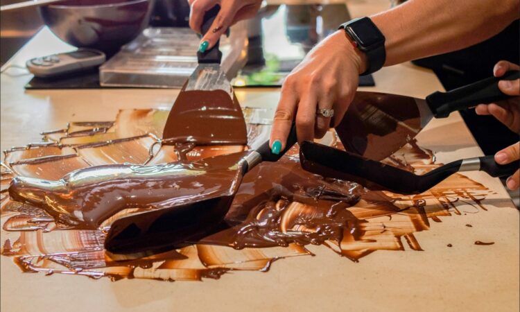 Hands-on Chocolate Master Class, teaching participants how to craft rich, artisanal chocolate from cacao beans, with techniques for tempering, molding, and flavoring.