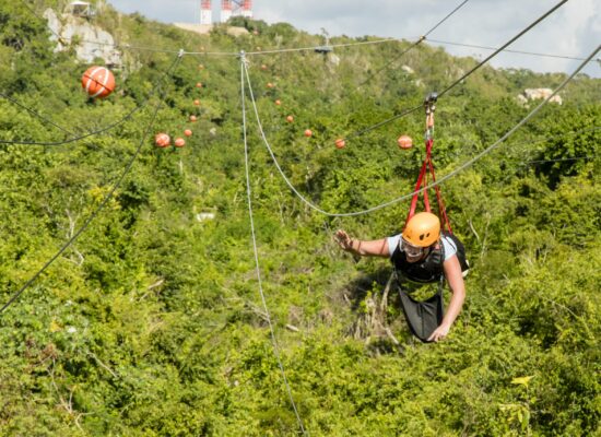 Adventure-filled Scape Park in Punta Cana, showcasing lush tropical landscapes, zip lines, underground caves, and natural cenotes for visitors to explore and enjoy