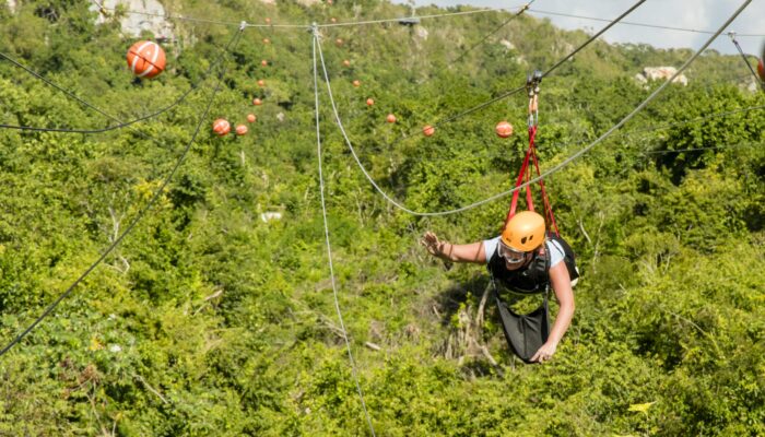 Adventure-filled Scape Park in Punta Cana, showcasing lush tropical landscapes, zip lines, underground caves, and natural cenotes for visitors to explore and enjoy