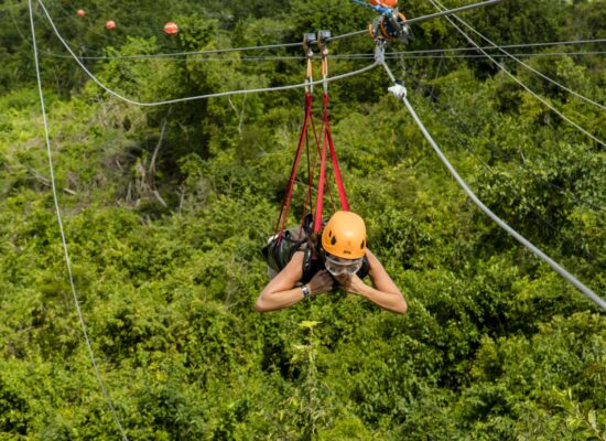 Adventure-filled Scape Park in Punta Cana, showcasing lush tropical landscapes, zip lines, underground caves, and natural cenotes for visitors to explore and enjoy