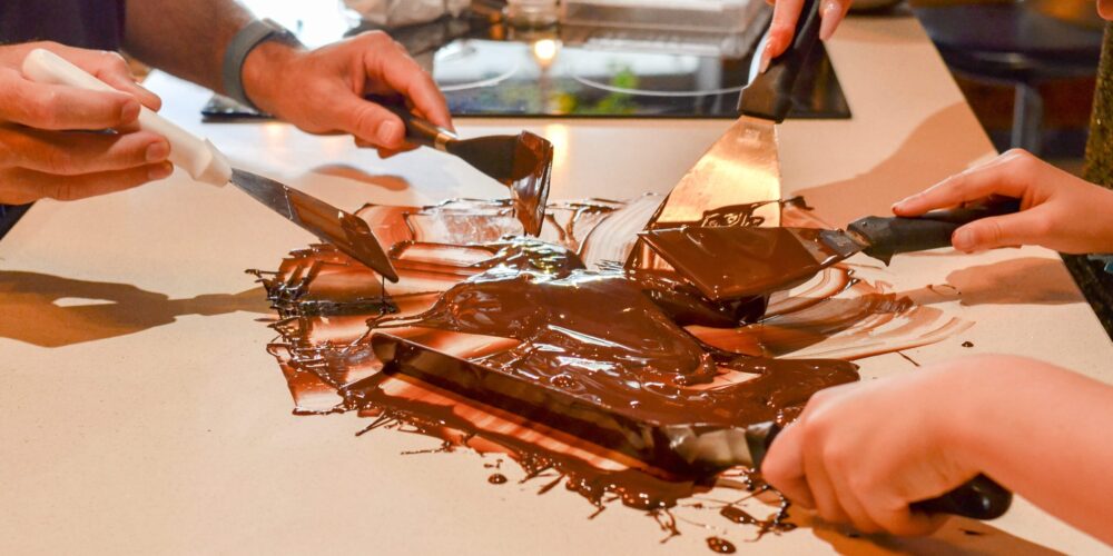 Hands-on Chocolate Master Class, teaching participants how to craft rich, artisanal chocolate from cacao beans, with techniques for tempering, molding, and flavoring.