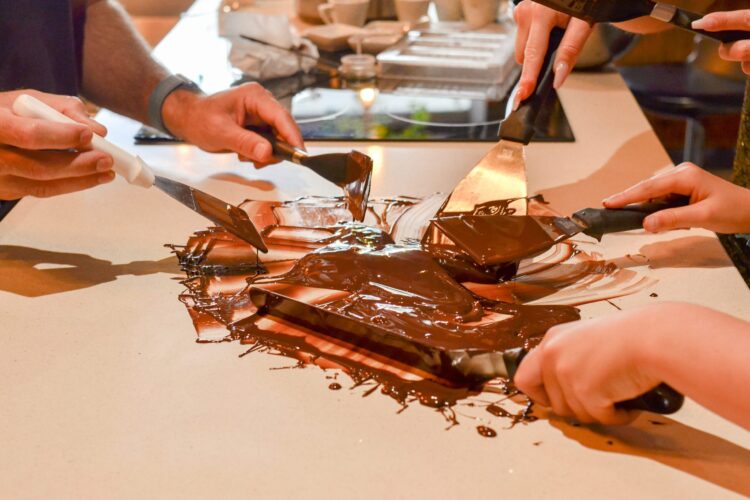 Hands-on Chocolate Master Class, teaching participants how to craft rich, artisanal chocolate from cacao beans, with techniques for tempering, molding, and flavoring.