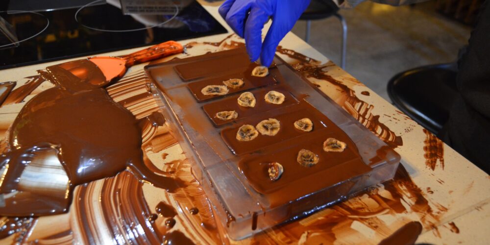 Hands-on Chocolate Master Class, teaching participants how to craft rich, artisanal chocolate from cacao beans, with techniques for tempering, molding, and flavoring.