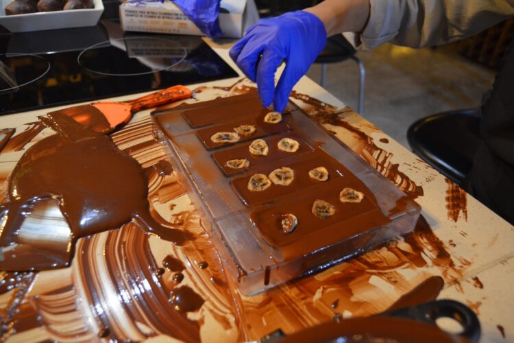 Hands-on Chocolate Master Class, teaching participants how to craft rich, artisanal chocolate from cacao beans, with techniques for tempering, molding, and flavoring.