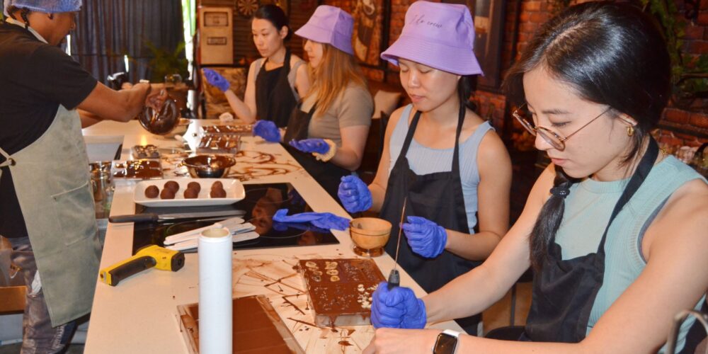 Hands-on Chocolate Master Class, teaching participants how to craft rich, artisanal chocolate from cacao beans, with techniques for tempering, molding, and flavoring.