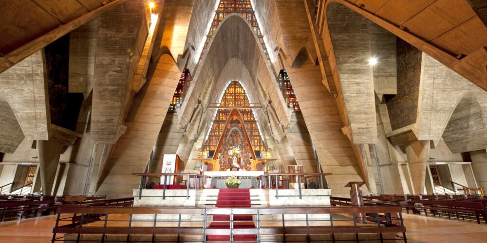 Iconic view of the Higüey Cathedral, also known as La Basilica, featuring its towering arched structure and modern architectural design, a famous religious landmark in the Dominican Republic.