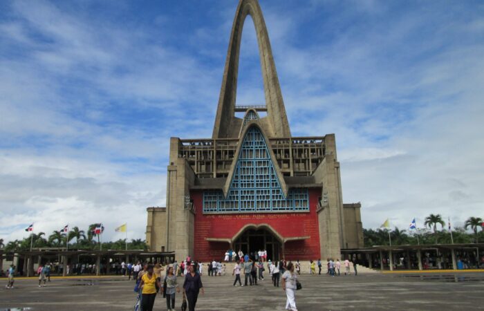 Iconic view of the Higuey Cathedral, also known as La Basílica, featuring its towering arched structure and modern architectural design, a famous religious landmark in the Dominican Republic.