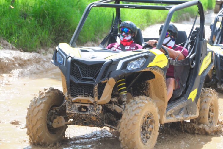 Couple on a thrilling half-day buggy adventure in Punta Cana with Can-Am and Honda 700cc vehicles