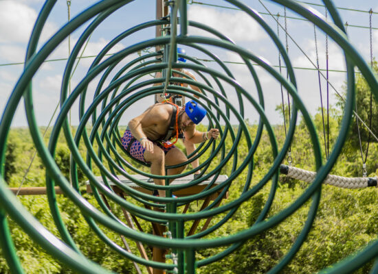 Adventure-filled Scape Park in Punta Cana, showcasing lush tropical landscapes, zip lines, underground caves, and natural cenotes for visitors to explore and enjoy