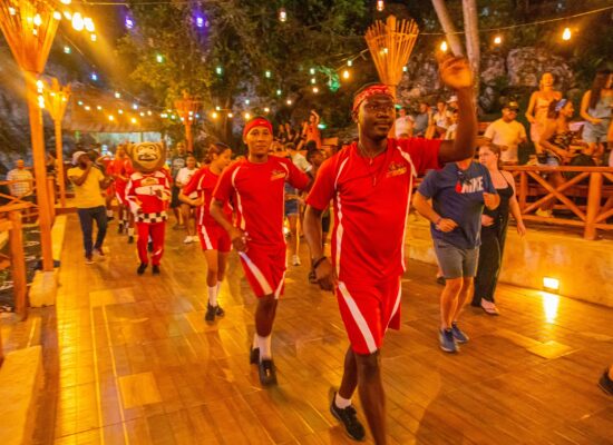 Colorful Carnival Show featuring lively dancers in extravagant costumes, vibrant masks, and rhythmic music, celebrating the festive spirit and cultural heritage of the Caribbean.