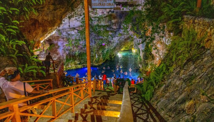 Refreshing cave swim in crystal clear water, surrounded by stunning rock formations and natural beauty, offering a serene and unique swimming experience in an underground cenote.