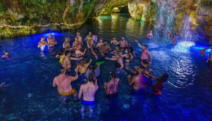 Refreshing cave swim in crystal clear water, surrounded by stunning rock formations and natural beauty, offering a serene and unique swimming experience in an underground cenote.