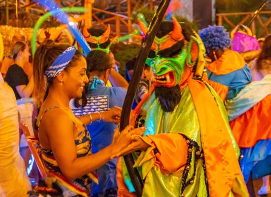 Colorful Carnival Show featuring lively dancers in extravagant costumes, vibrant masks, and rhythmic music, celebrating the festive spirit and cultural heritage of the Caribbean.