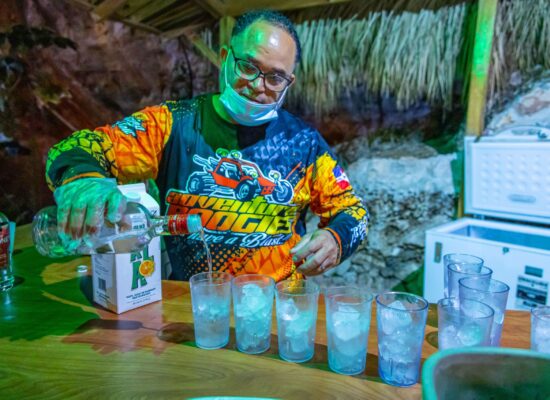 Friendly staff serving refreshing drinks to guests during the Buggy Night Tour, enhancing the adventure with a relaxing beverage break under the night sky.