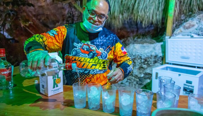 Friendly staff serving refreshing drinks to guests during the Buggy Night Tour, enhancing the adventure with a relaxing beverage break under the night sky.